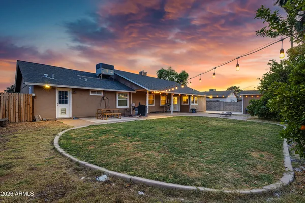 a view of a swimming pool with a bench and trees