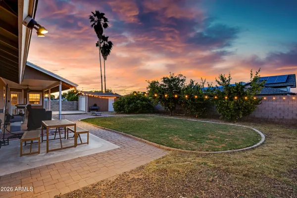 a backyard of a house with lots of green space and lake view