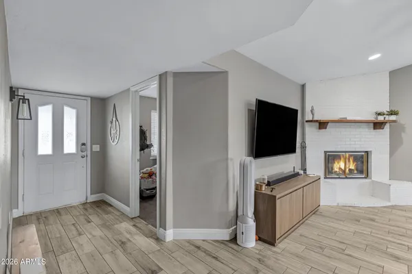 a view of a livingroom with an empty space and a fireplace