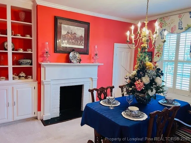 a view of a dining room with furniture and chandelier