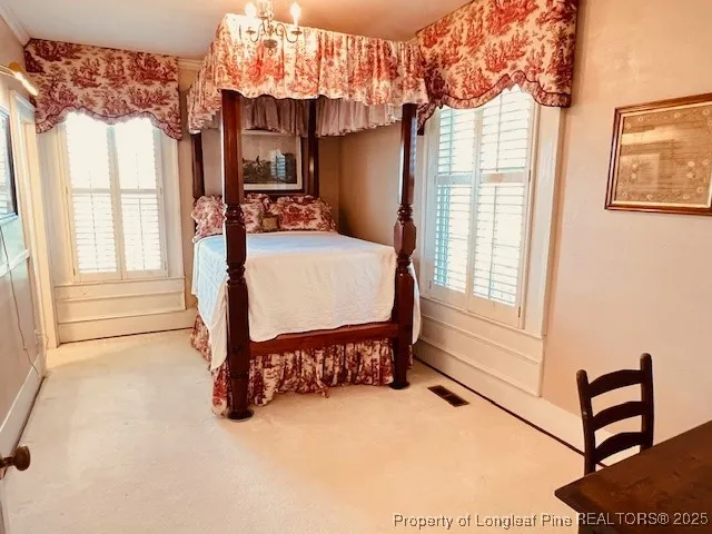 a bed room with a bed and a window