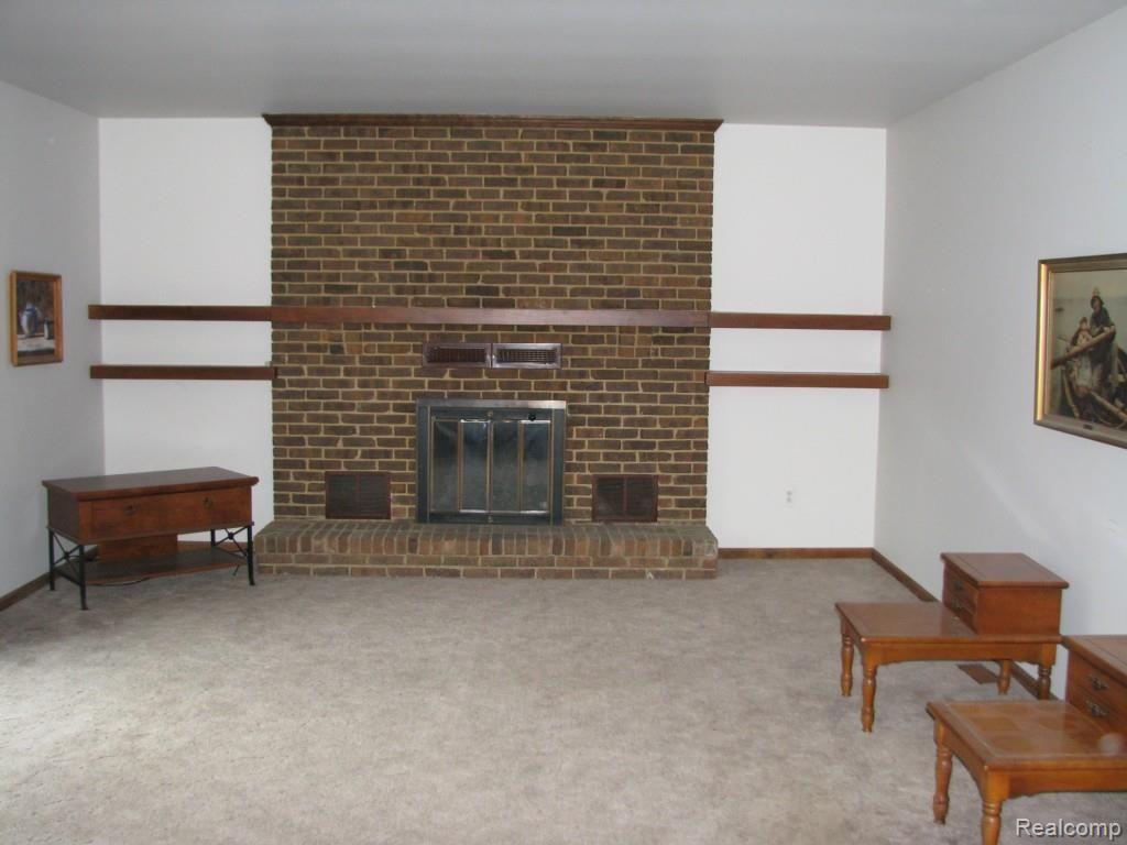 9334 Hilton Road Brighton, MI 48114 - Photo 18 of 34 Family room with gas fired natural masonry fireplace