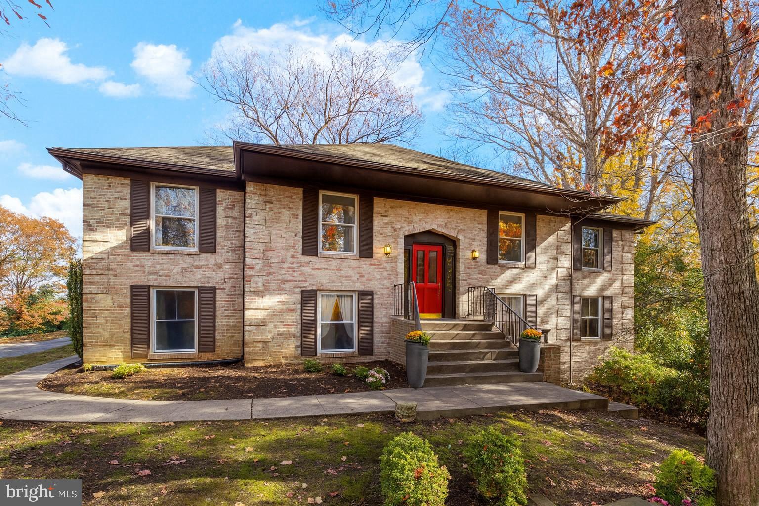 Charming brick home with vibrant red door.