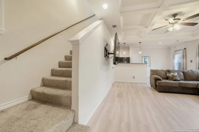 a view of a livingroom with furniture and stairs