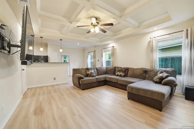a living room with furniture and a chandelier