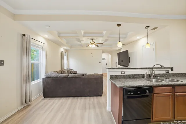 a living room with kitchen island granite countertop furniture and fireplace
