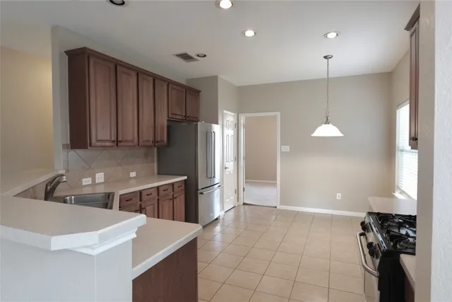 a kitchen with a refrigerator and a sink