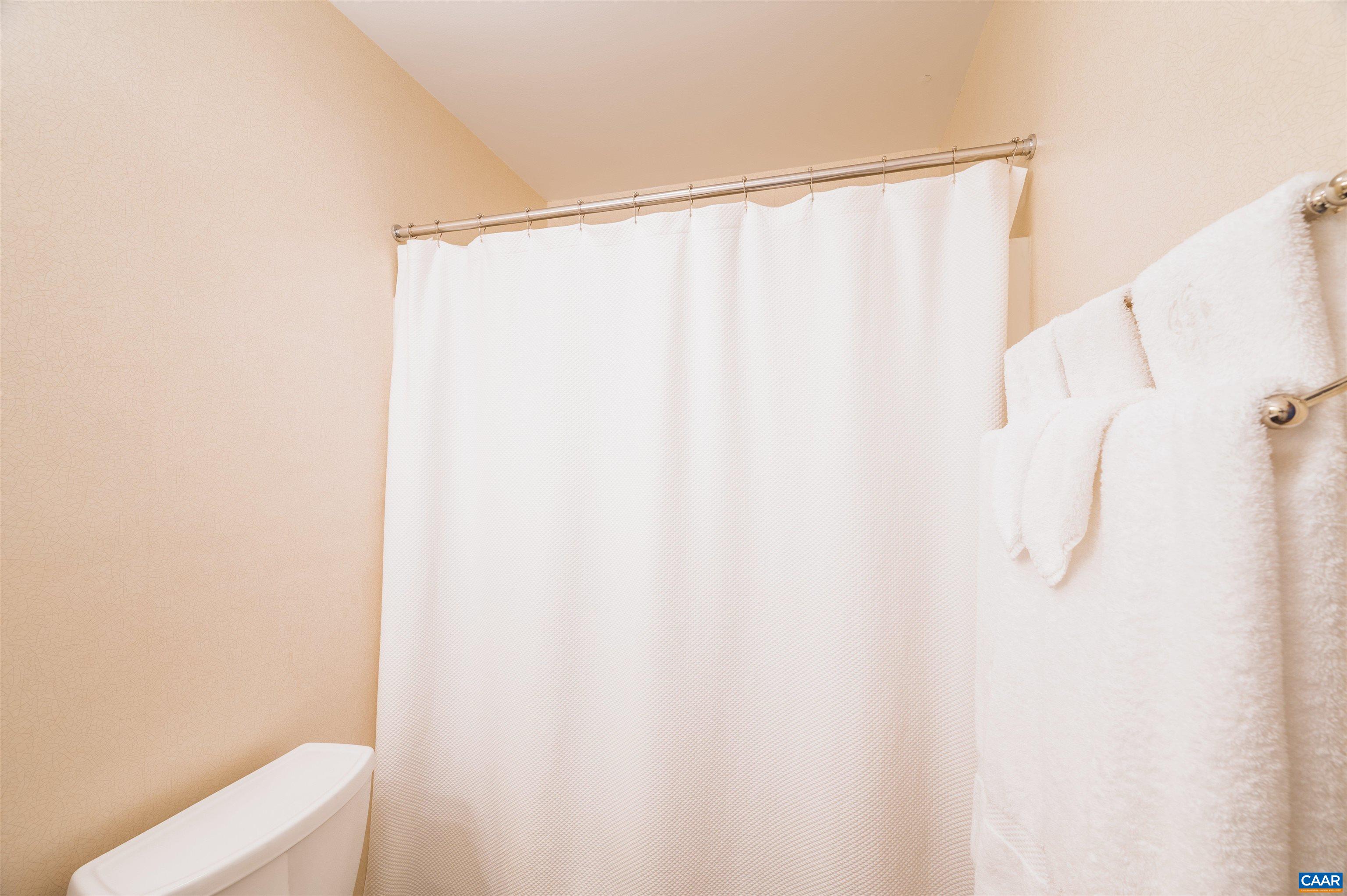 32 Out Of Bounds Road Palmyra, VA 22963 - Photo 25 of 55 a bathroom with a shower curtain and sink