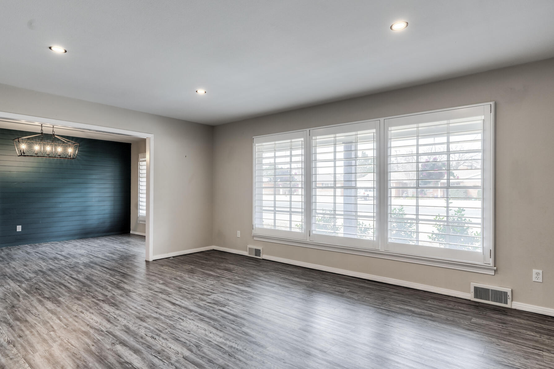 3303 53rd Street Lubbock, TX 79413 - Photo 12 of 72 wooden floor in an empty room with a window
