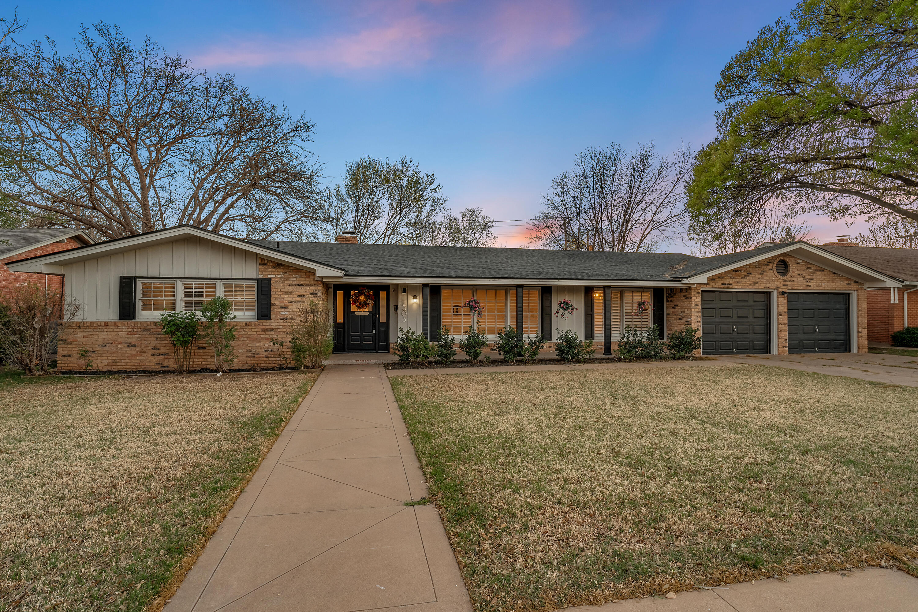 3303 53rd Street Lubbock, TX 79413 - Photo 2 of 72 a front view of a house with yard and parking