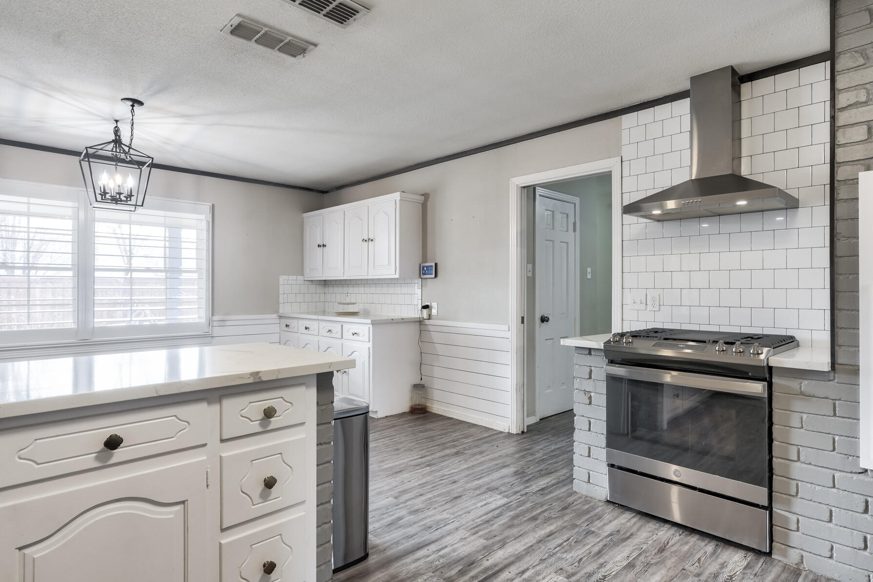3303 53rd Street Lubbock, TX 79413 - Photo 22 of 72 a kitchen that has a stove and a microwave