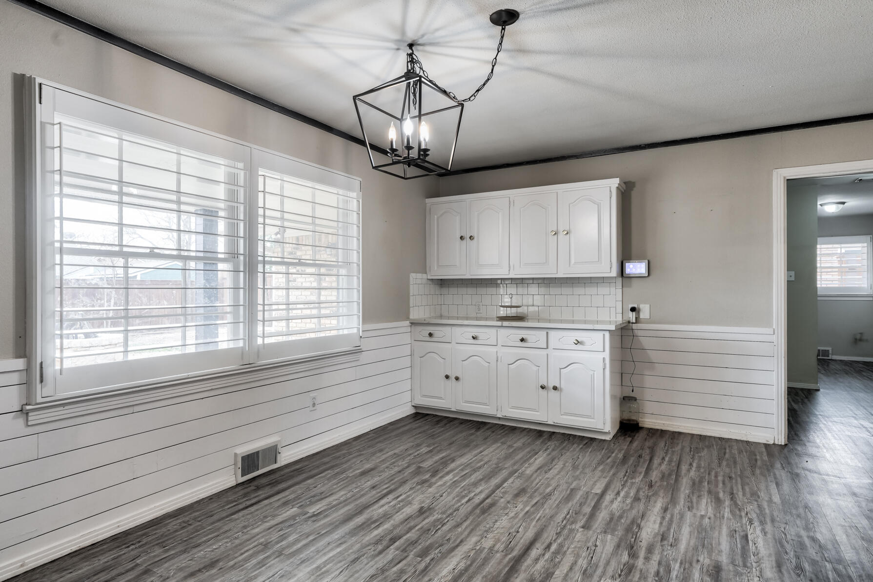 3303 53rd Street Lubbock, TX 79413 - Photo 23 of 72 a kitchen with appliances cabinets and a wooden floor