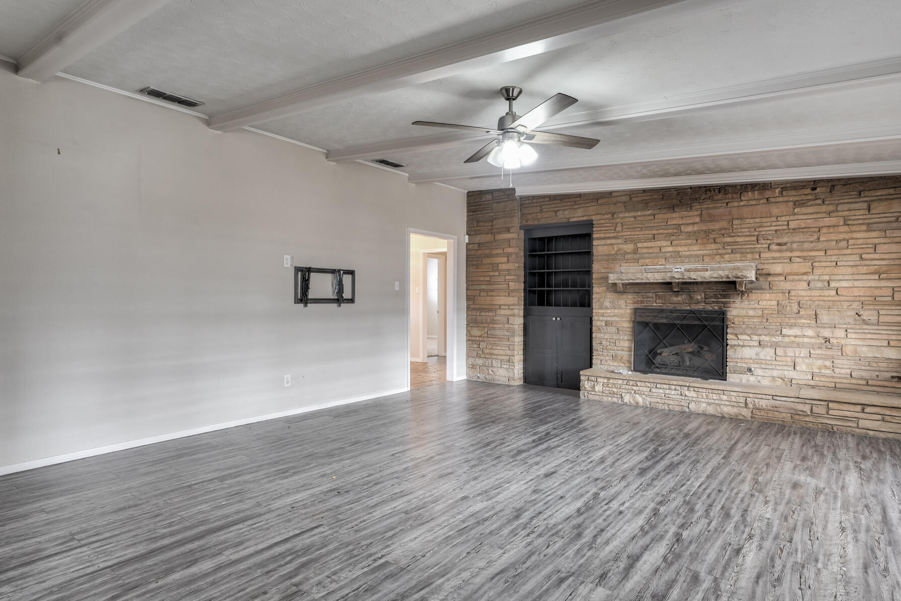3303 53rd Street Lubbock, TX 79413 - Photo 26 of 72 a view of an empty room with wooden floor fireplace and a window