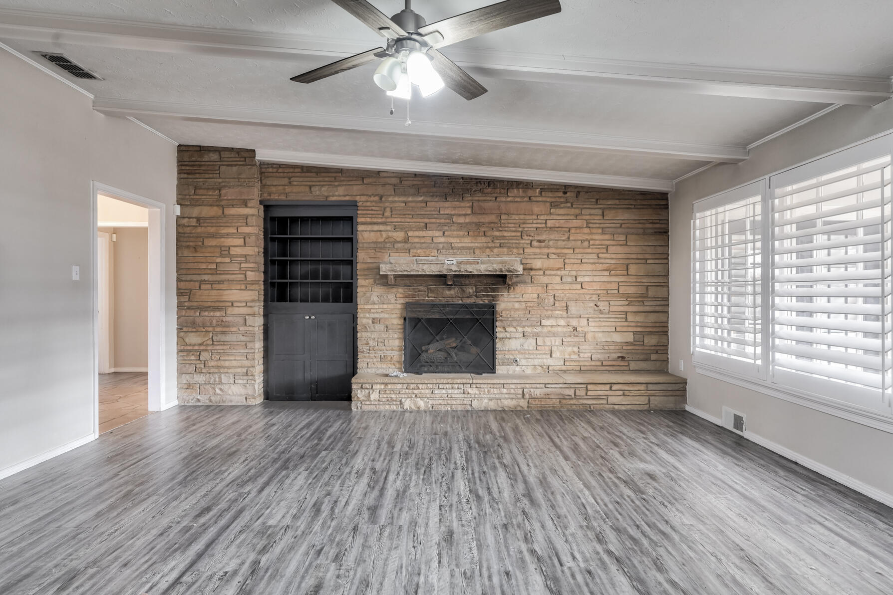 3303 53rd Street Lubbock, TX 79413 - Photo 28 of 72 wooden floor fireplace and windows in an empty room