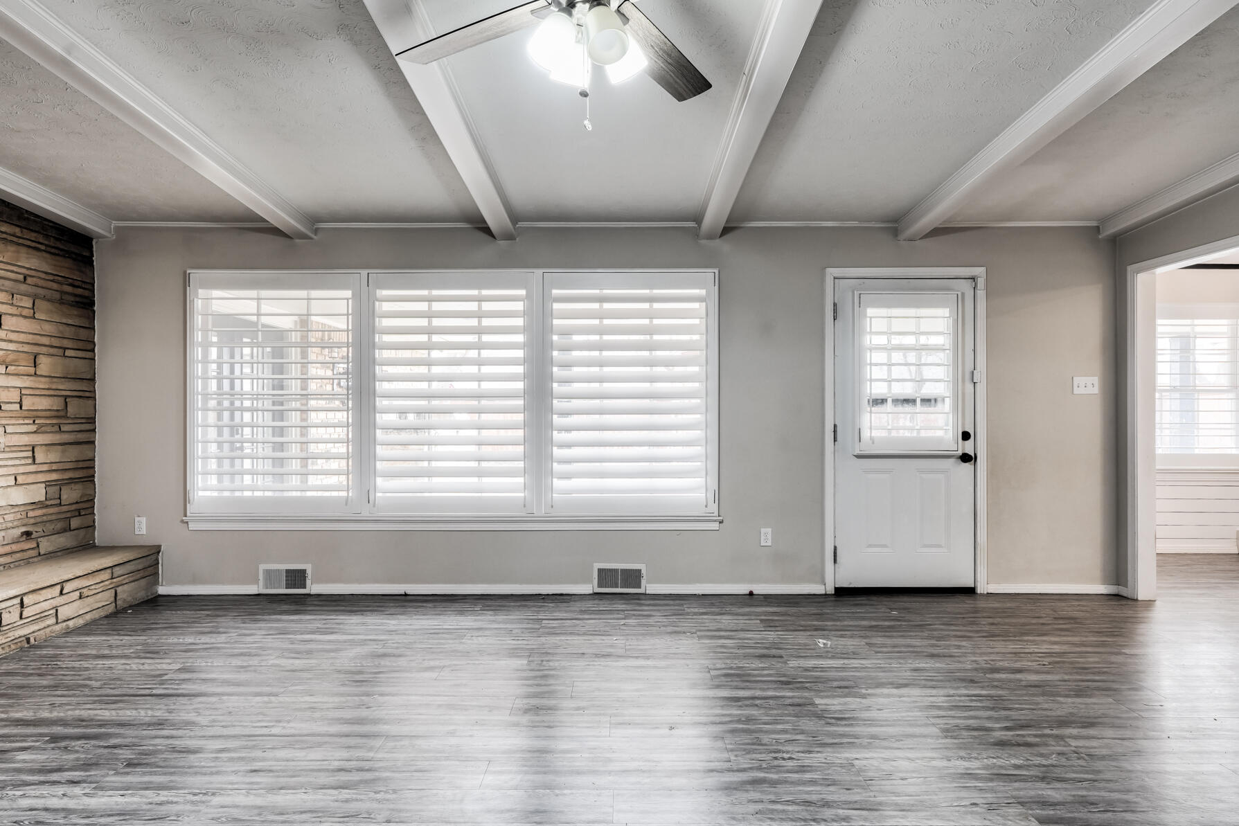 3303 53rd Street Lubbock, TX 79413 - Photo 30 of 72 a view of an empty room with wooden floor and a window