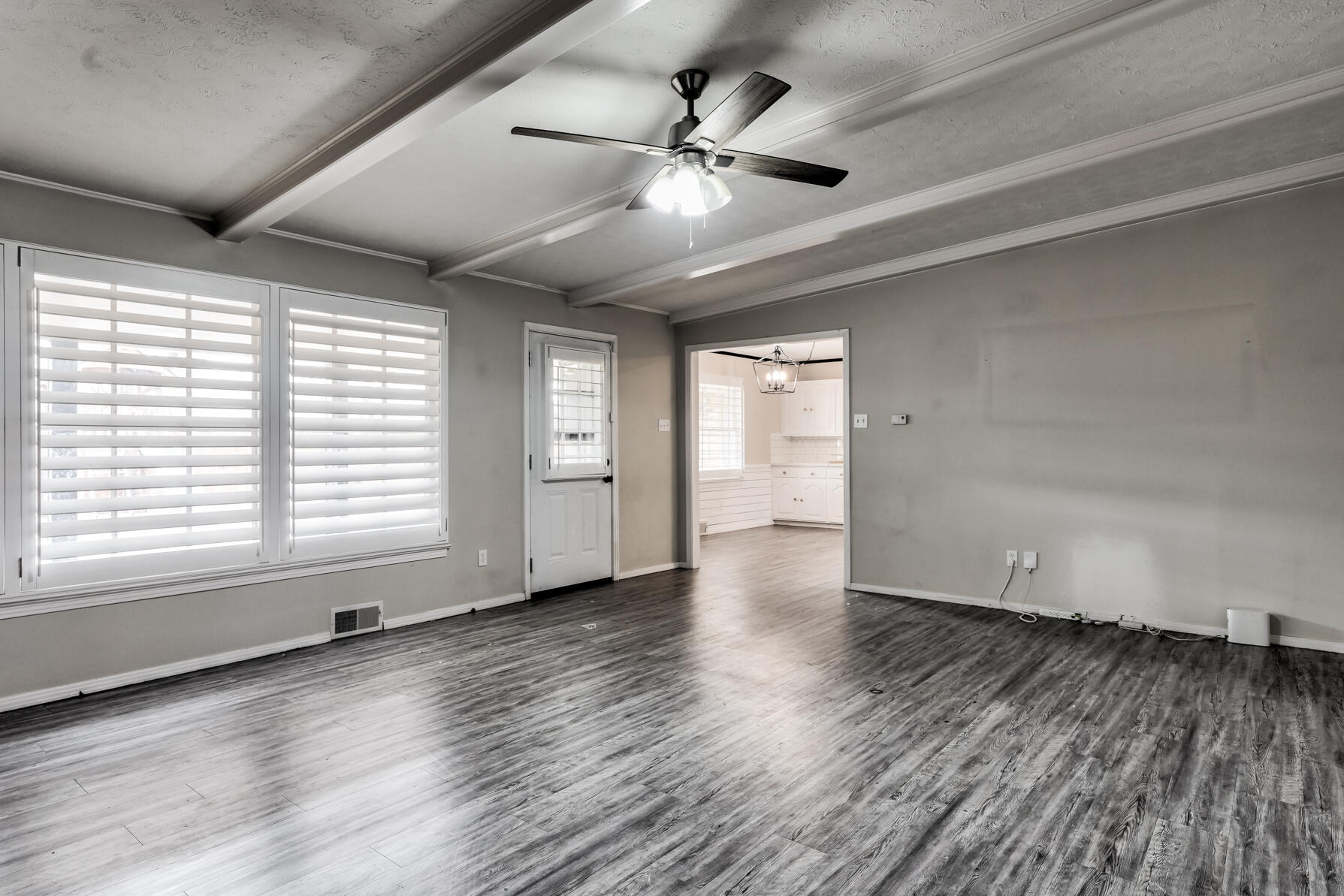 3303 53rd Street Lubbock, TX 79413 - Photo 31 of 72 a view of an empty room with wooden floor and a window