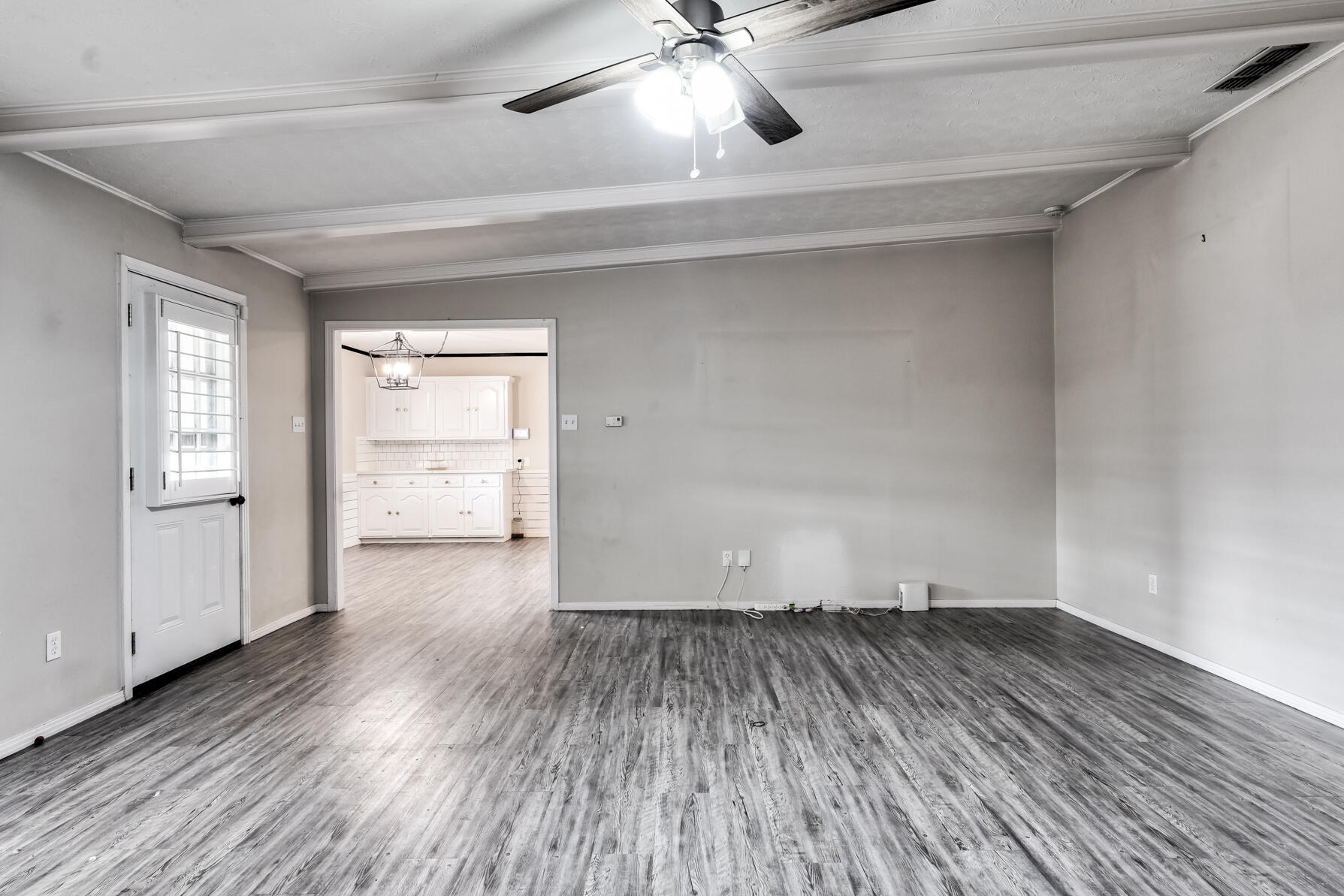 3303 53rd Street Lubbock, TX 79413 - Photo 32 of 72 a view of a room with wooden floors and ceiling fan