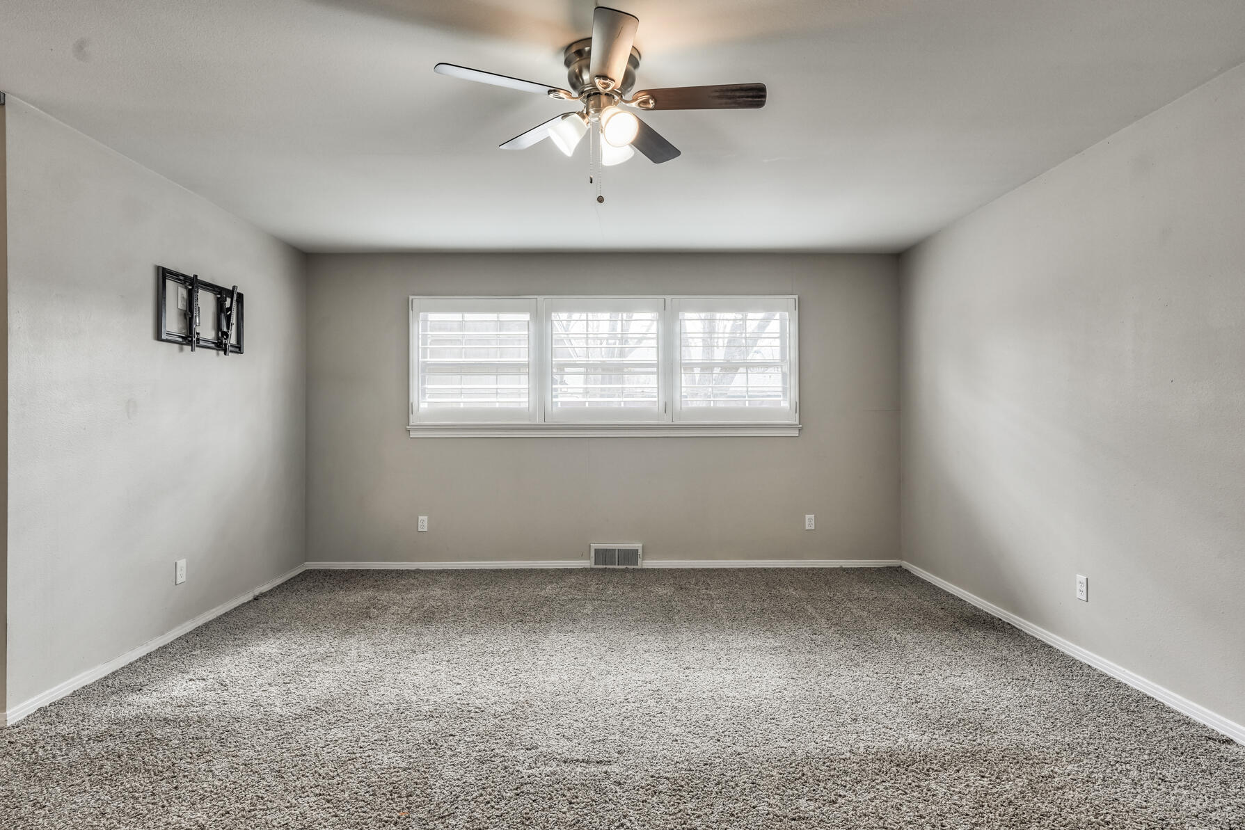 3303 53rd Street Lubbock, TX 79413 - Photo 35 of 72 an empty room with a window and a ceiling fan