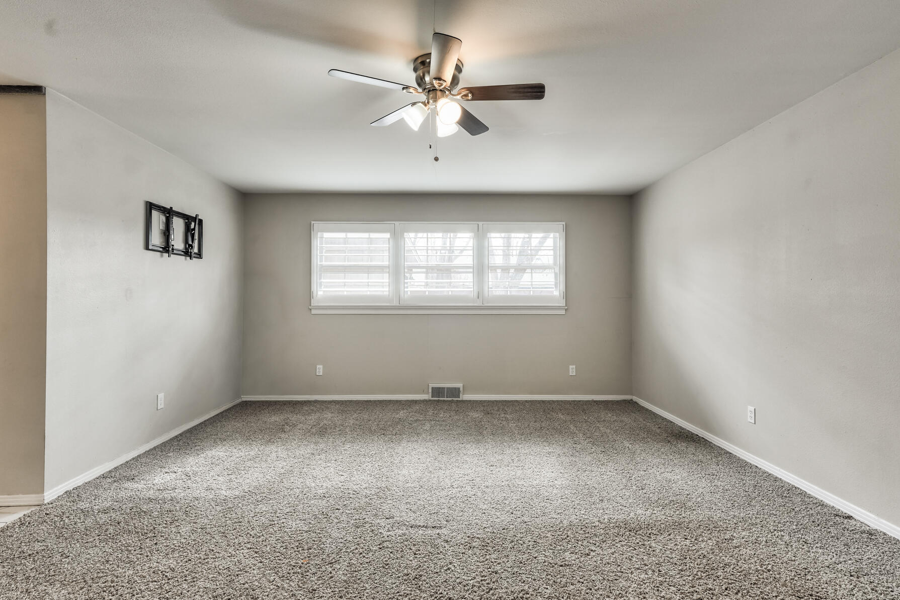 3303 53rd Street Lubbock, TX 79413 - Photo 36 of 72 an empty room with chandelier fan and windows