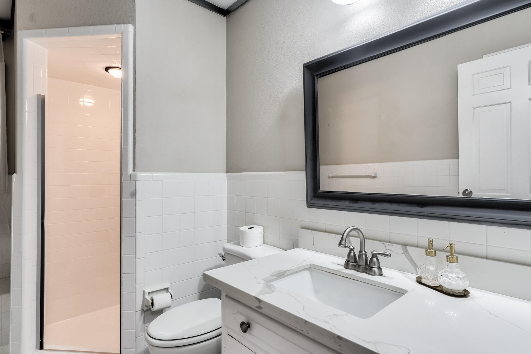 3303 53rd Street Lubbock, TX 79413 - Photo 41 of 72 a bathroom with a granite countertop toilet sink and mirror