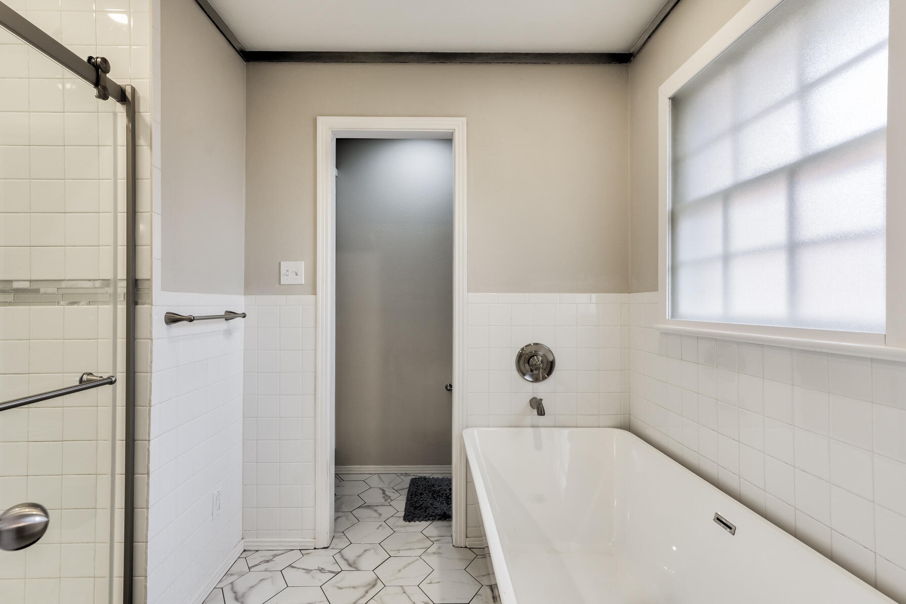 3303 53rd Street Lubbock, TX 79413 - Photo 46 of 72 a bathroom with a bathtub and a shower