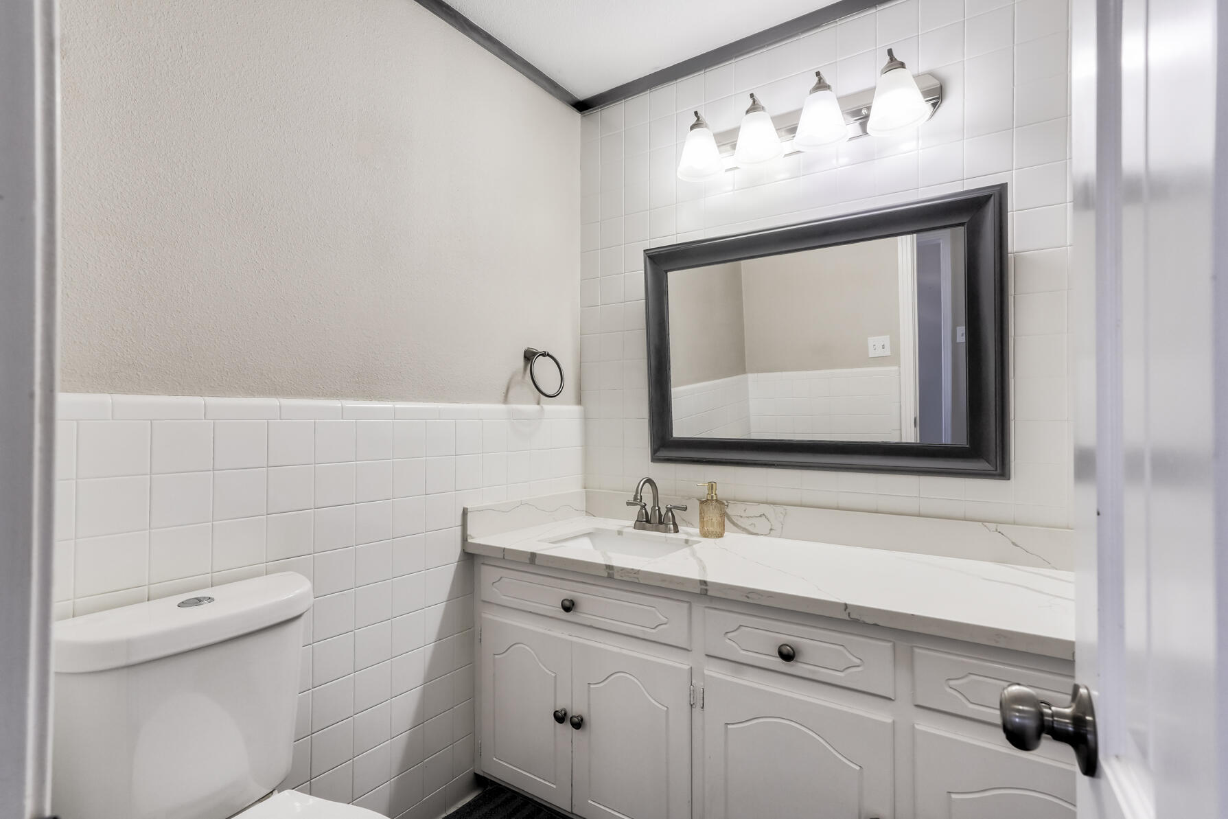 3303 53rd Street Lubbock, TX 79413 - Photo 54 of 72 a bathroom with a toilet sink and mirror