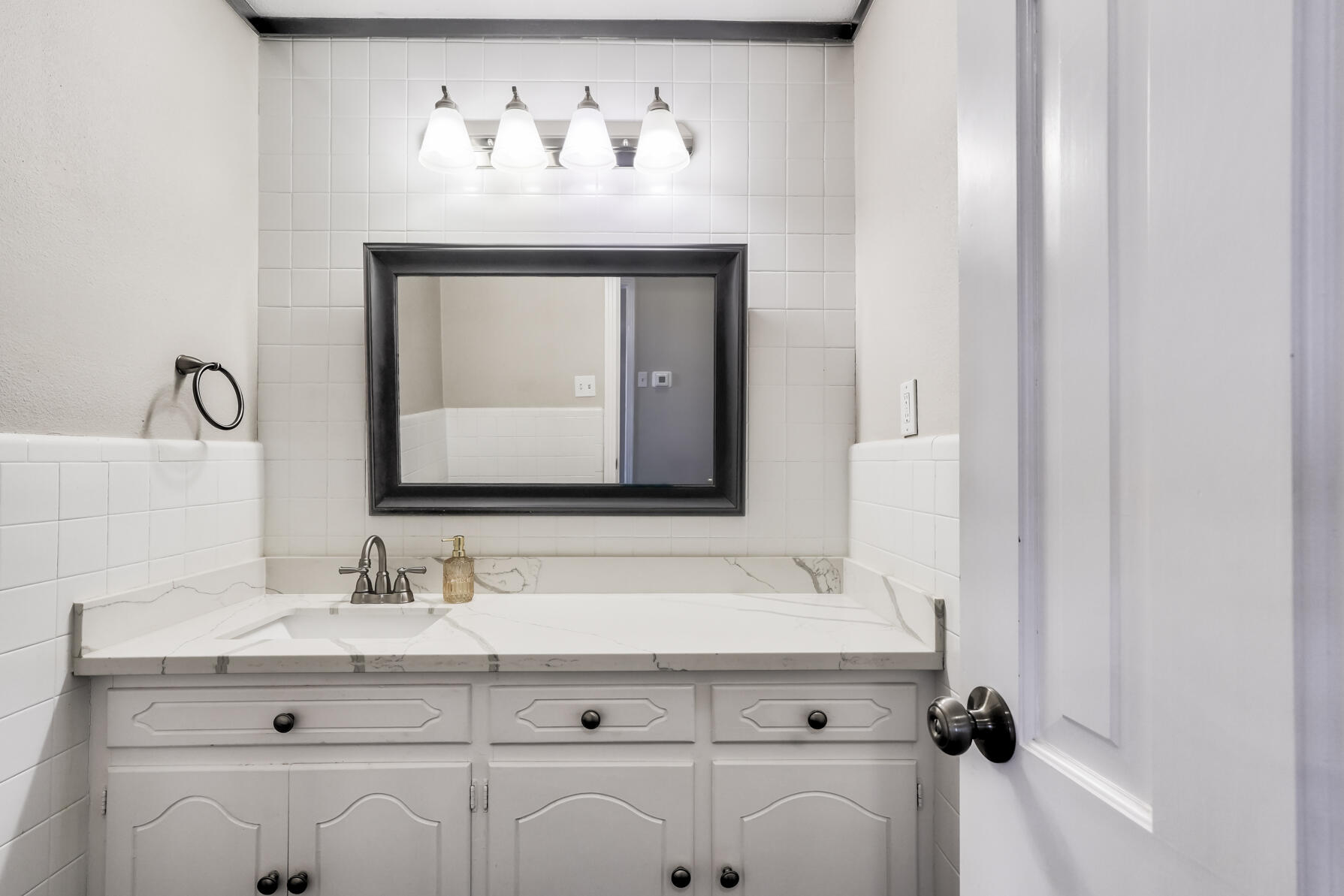 3303 53rd Street Lubbock, TX 79413 - Photo 55 of 72 a bathroom with a sink and a mirror