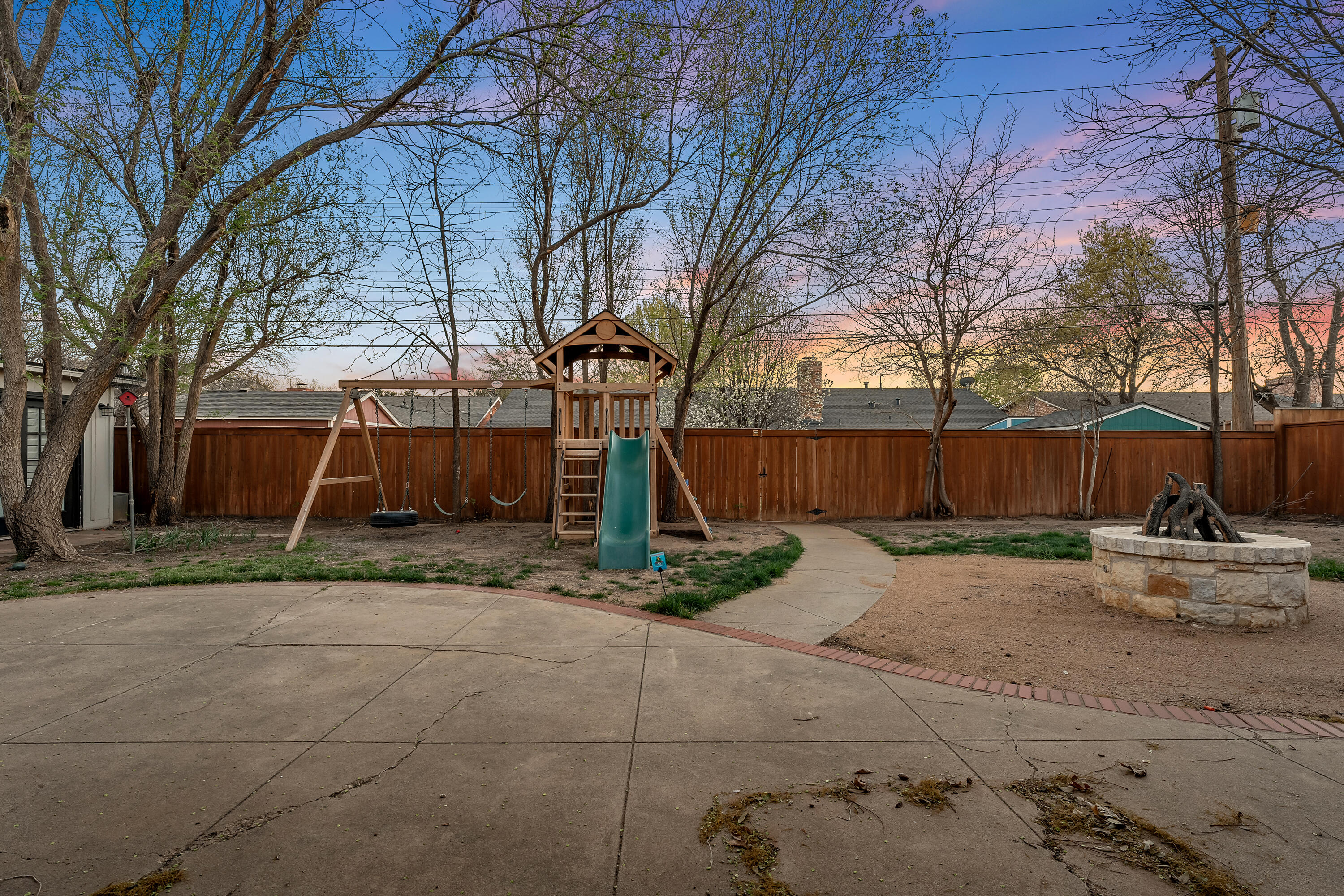 3303 53rd Street Lubbock, TX 79413 - Photo 59 of 72 a backyard of house with a swing and slide