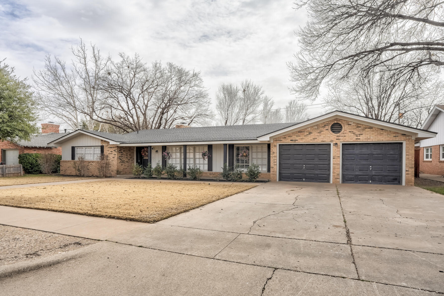 3303 53rd Street Lubbock, TX 79413 - Photo 6 of 72 a front view of a house with a yard and garage