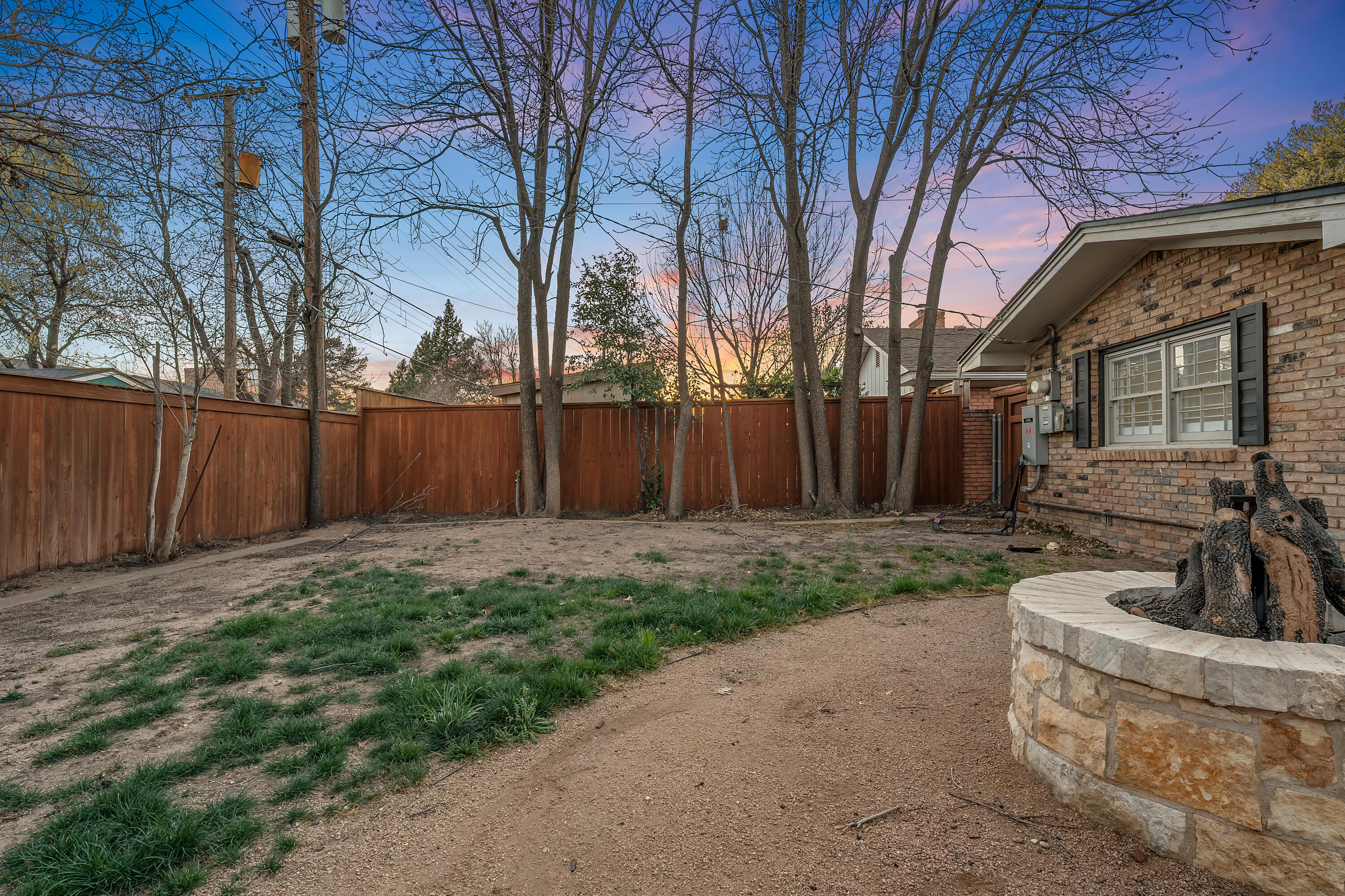 3303 53rd Street Lubbock, TX 79413 - Photo 61 of 72 a view of a backyard with table and chairs and wooden fence
