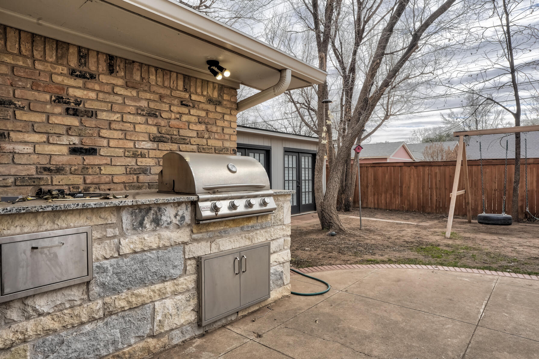 3303 53rd Street Lubbock, TX 79413 - Photo 65 of 72 a white house with a tree in front of it