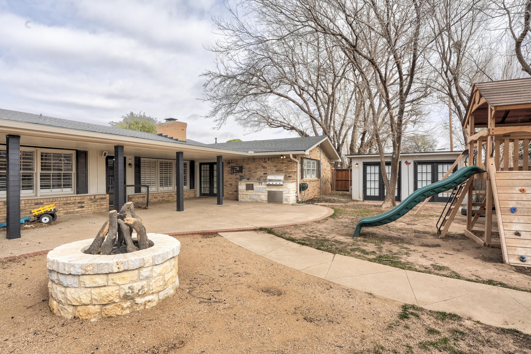 3303 53rd Street Lubbock, TX 79413 - Photo 67 of 72 a front view of a house with a yard and fountain in middle