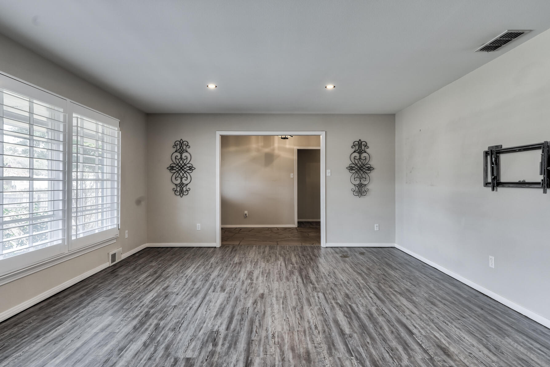 3303 53rd Street Lubbock, TX 79413 - Photo 10 of 72 an empty room with wooden floor and windows