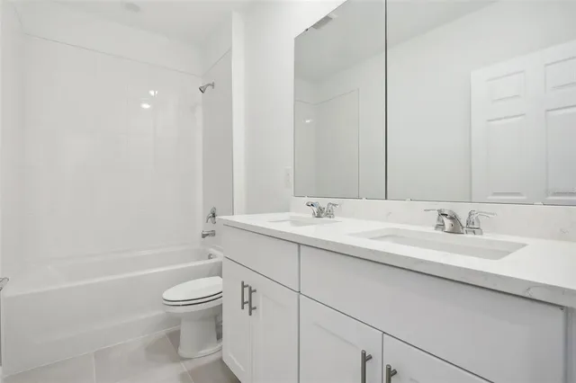 a bathroom with a toilet a sink a vanity and mirror