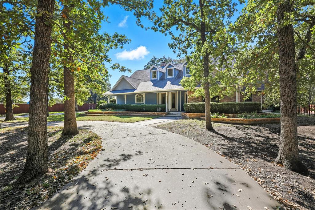 Cape cod home featuring covered porch