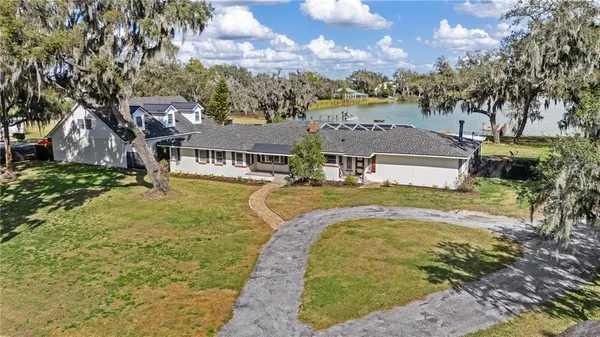 a view of a house with backyard and porch
