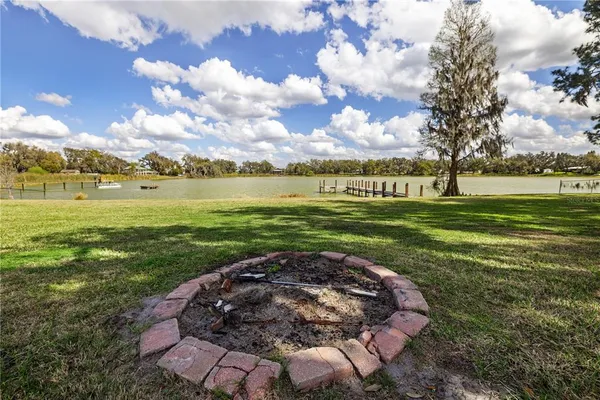 a kitchen with granite countertop a sink cabinets stainless steel appliances and a counter space
