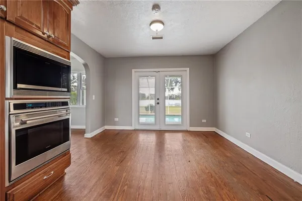 a view of empty room with wooden floor