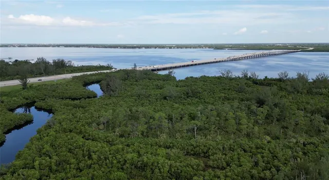 a view of a lake with a yard and mountain in the back