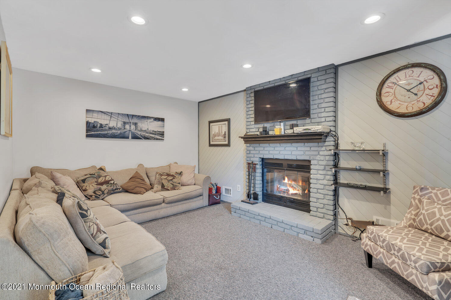181 Friendship Road Howell, NJ 07731 - Photo 17 of 36 a living room with furniture a flat screen tv and a fireplace