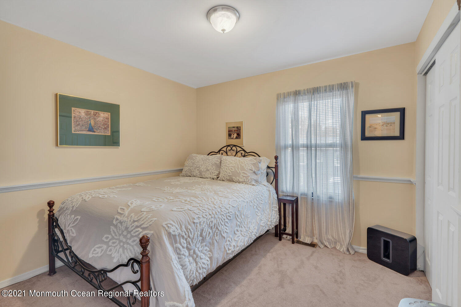 181 Friendship Road Howell, NJ 07731 - Photo 24 of 36 a bedroom with a bed and a chair