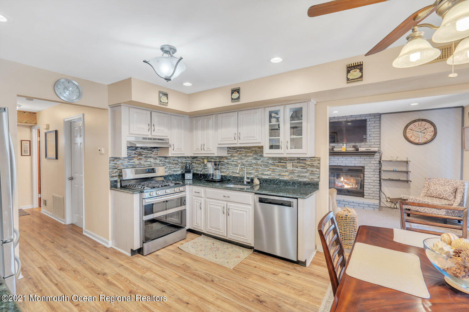 181 Friendship Road Howell, NJ 07731 - Photo 7 of 36 a kitchen with stainless steel appliances granite countertop a stove top oven a refrigerator a sink dishwasher and white cabinets with wooden floor