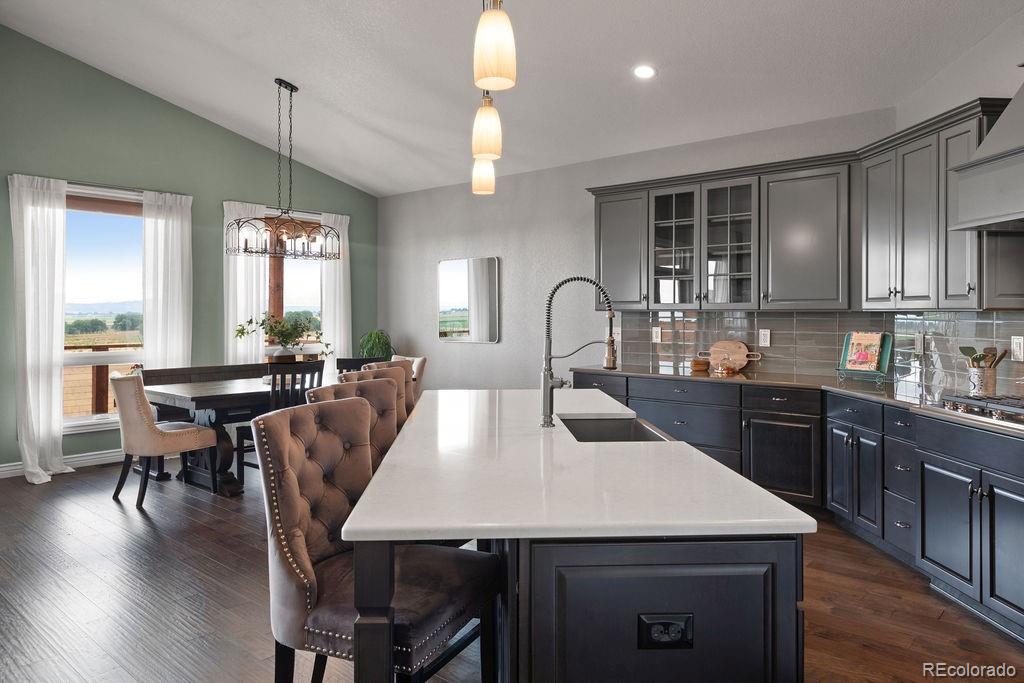 3050 Native Court Wellington, CO 80549 - Photo 11 of 50 a large kitchen with a table chairs sink and wooden floor