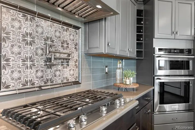 a kitchen with granite countertop a stove and cabinets