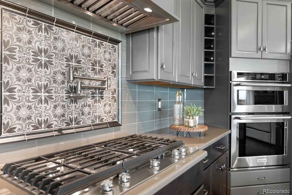 3050 Native Court Wellington, CO 80549 - Photo 12 of 50 a kitchen with granite countertop a stove and cabinets