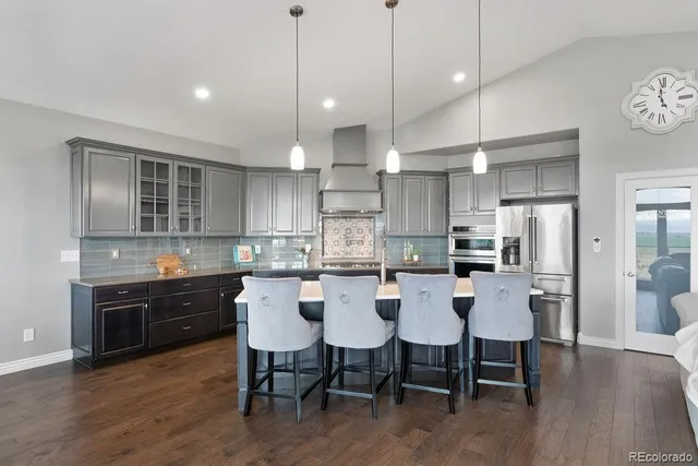 a large kitchen with a table and chairs