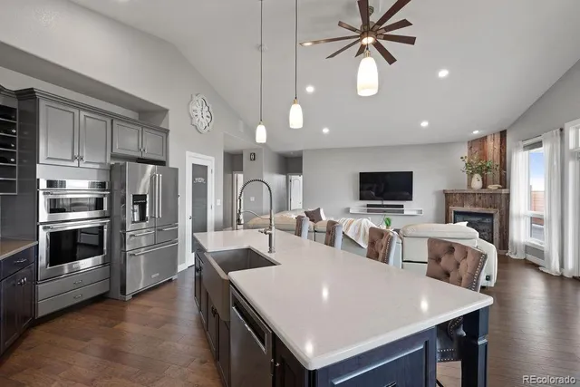 a large kitchen with a table chairs refrigerator and microwave