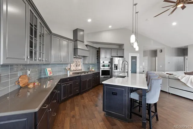 a large kitchen with stainless steel appliances lots of counter space and breakfast area