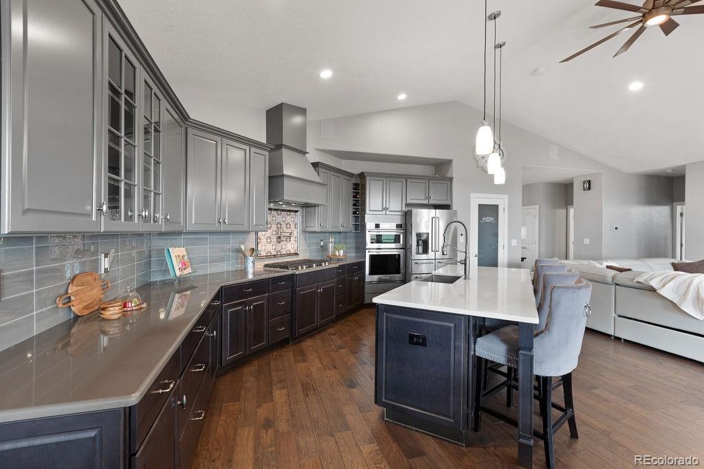 3050 Native Court Wellington, CO 80549 - Photo 15 of 50 a large kitchen with stainless steel appliances lots of counter space and breakfast area