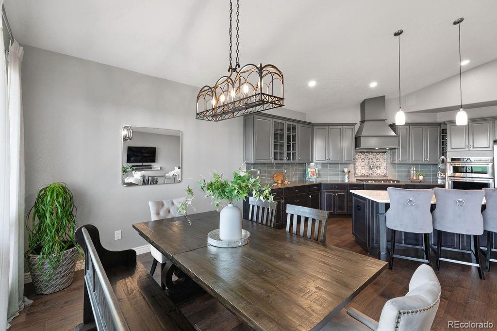 3050 Native Court Wellington, CO 80549 - Photo 17 of 50 a dining room filled chandelier and kitchen view